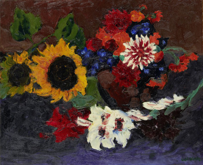 Basket of flowers with sunflowers and dahlias against a dark background, arranged in vivid, high-contrast colours.